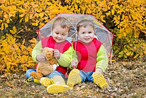 Happy toddler children under an umbrella