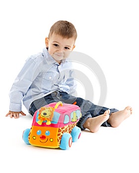 Happy toddler with colorful toy car