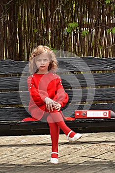 Happy toddler girl with a big red binder