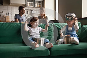 Happy preschool cute girl and boy playing with kitchenware toget