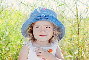 Happy toddler girl in in field