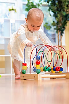 Happy toddler girl playing with toys