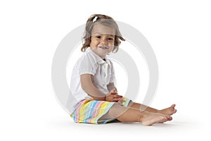 Happy toddler girl sitting on the floor
