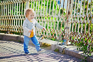 Happy toddler girl walking in the street of Helsinki, Finland