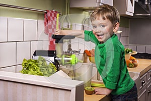 Happy toddler making green juice