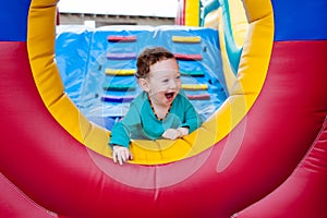 Happy toddler peeking on trampoline photo