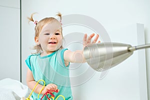 Happy toddler plays with a naphtha lamp