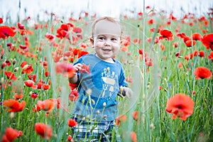 happy toddler smiling in a field of poppies