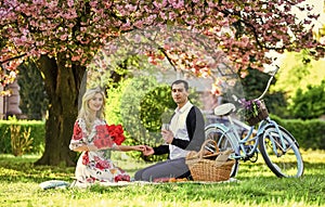 Happy together. couple in love on green grass. enjoying nature together. having picnic in city park. man and woman relax