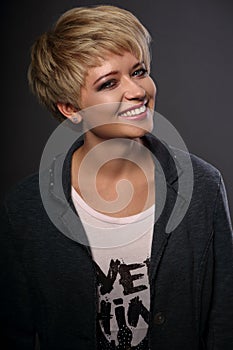 Happy toothy smiling young blond woman with short bob hair style