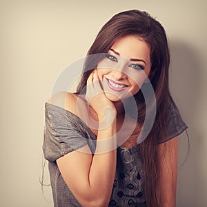 Happy toothy smiling young woman with long hair in fashion blouse. Coseup vintage toned portrait photo