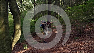 Happy Tourist with backpack Hiking on Adventure Trip. Man funny dancing in forest.