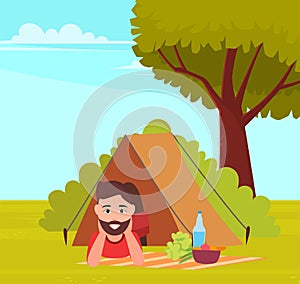 Happy tourist or backpacker lying in tent. Male character with food and drink in tent in forest