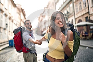 Happy tourist couple sightseeing; Traveller lifestyle
