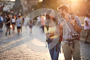 Happy tourist couple sightseeing; Traveller lifestyle