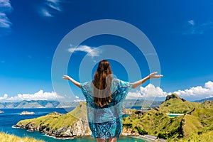 Happy tourist enjoying the breeze during summer vacation in Padar Island