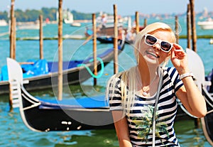 Happy Tourist and Gondolas in Venice, Italy. Cheerful Blonde