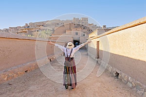 Happy tourist with open arms at Ait Ben Haddu Marocco beautiful place to visite in morocco photo