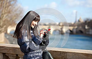 Happy tourist in Paris sending an sms