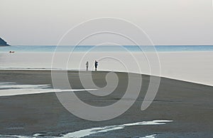 Happy tourist silhouette enjoying morning beach walk