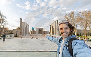 happy tourist take photo selfie with Registan in Samarkand, travel in Uzbekistan, Central Asia