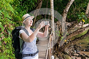 Happy tourist on vacation photographs beautiful landscapes