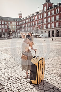 Happy tourist woman in spain traveling around europe post-covid