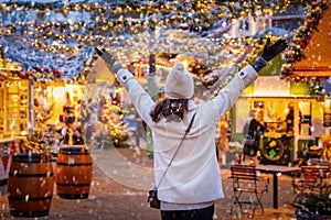 A happy tourist woman stands on a christmas market in Copenhagen