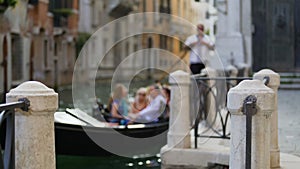 Happy tourists enjoying gondola ride around Venice sights, traditional transport