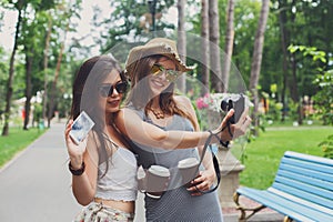 Happy tourists girl friends taking selfie photos