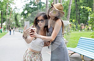 Happy tourists girl friends taking selfie photos