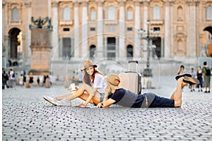 Happy tourists looking at a map and drinking coffee take away. Couple of tourists on vacation in Rome, Italy. Honeymoon