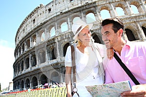 Happy tourists visiting Coliseum with map