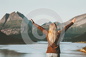 Happy Travel Woman tourist hands raised enjoying Norway sunset mountains and sea landscape Lifestyle concept adventure v