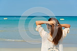 Happy traveler Asian woman enjoy at tropical beach on vacation. Summer on beach concept