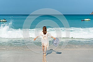 Happy traveler Asian woman  enjoys at tropical beach on vacation. Summer on beach concept