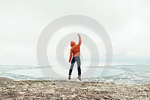 Happy traveler guy jumping outdoor