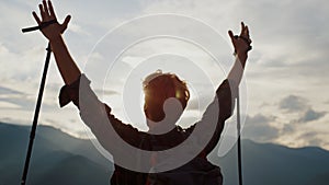 Happy traveler hike mountains closeup. Young tourist reach peak on nature sunset