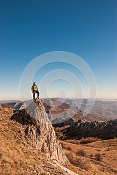 A happy traveler on a mountain top