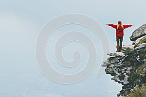 Happy traveler standing on cliff mountain hands raised Travel Lifestyle success motivation concept adventure active vacations outd