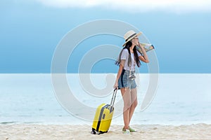Happy traveler and tourism young women travel summer on the beach.