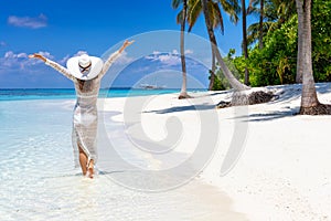 Traveler woman enjoys her tropical beach vacation
