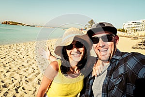 Happy traveling couple making selfie sea background. Summer beach holidays. Romantic mood. Stylish sunglasses. Happy laughing