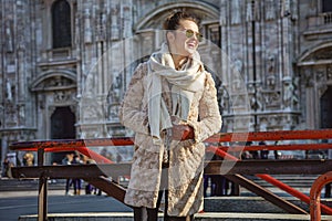 Happy traveller woman in Milan, Italy looking into distance