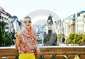 Happy traveller woman on Vaclavske namesti in Prague with map photo