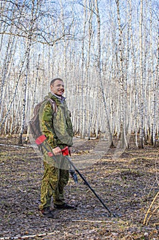 happy treasure hunter taking out ancient coins from the ground during a ban on searching for relics