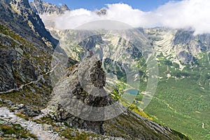 Happy trekking girl on the rock at High Tatras mountains, Slovak