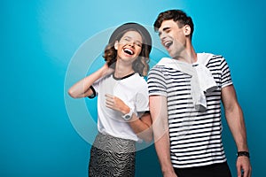 Happy, trendy man and woman laughing together