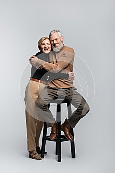 Happy and trendy mature couple hugging