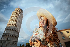 Happy trendy solo traveller woman in floral dress